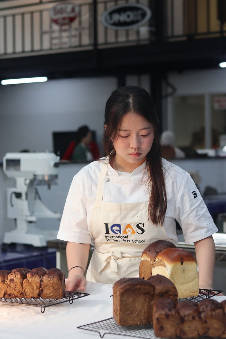 ICAS student presenting freshly baked bread