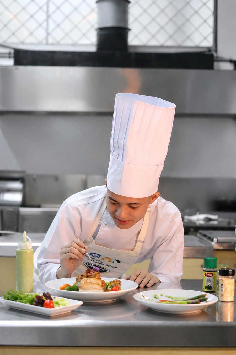 ICAS student plating a dish during the 3-Year Diploma in Culinary